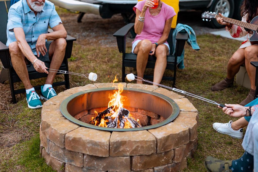 people roasting marshmallows over a fire pit